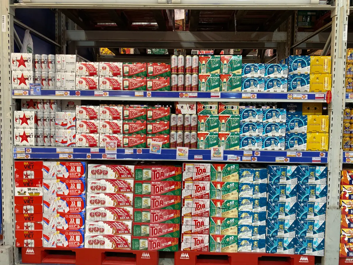 Wall of shelves stocked with toothpaste and personal care products in a warehouse-style market